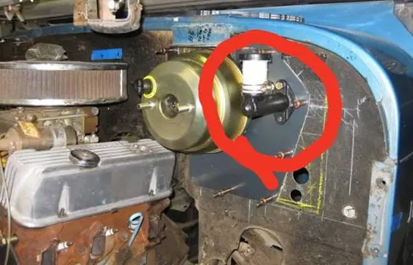 clutch master cylinder mounted on the firewall with its hydraulic line