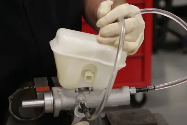 brake master cylinder failure inspection on a workbench